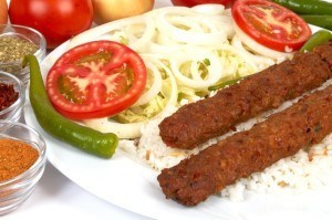 Adana kebap with rice and salads