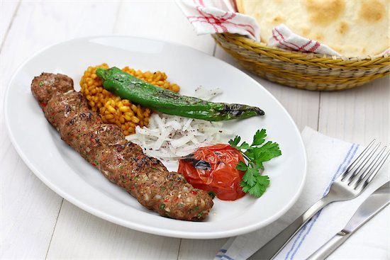 A dish of Kofte served with the delicious spice known as ground sumac.