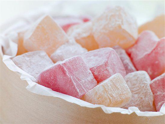 A container of Turkish Delights made with a variety of ingredients including rose water and fruits.