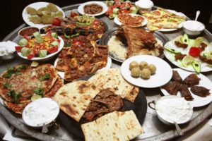 A table filled with several dishes of Turkish food. 
