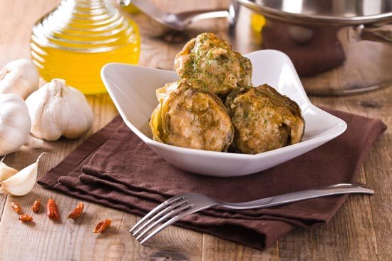 A dish containing celeriac root which has been stuffed with vegetables and baked.